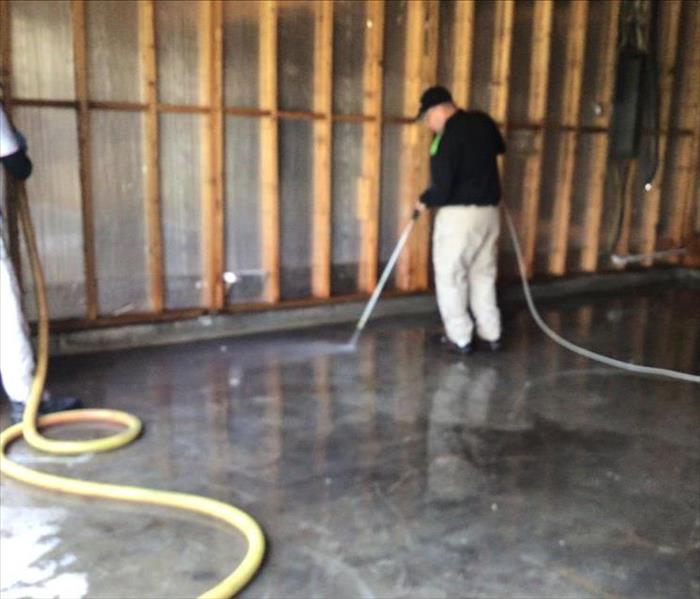 Concrete floor soot removal being performed by a SERVPRO professional 